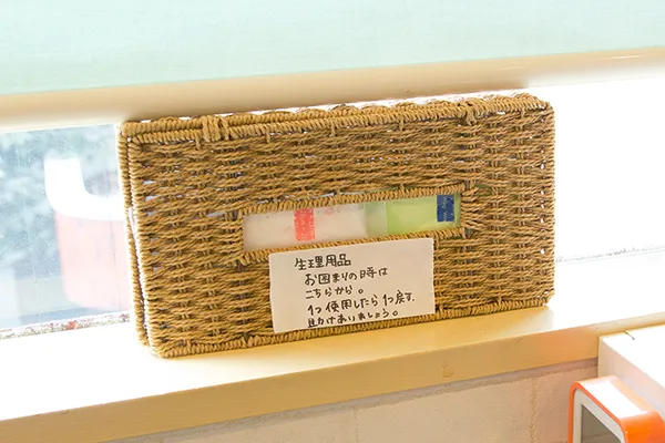 生理用品ボックス。「生理用品 お困りの時はこちらから。1つ使用したら1つ戻す。助けあいましょう。」と書いてある